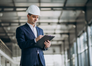 Handsome business man engineer in hard hat in a building